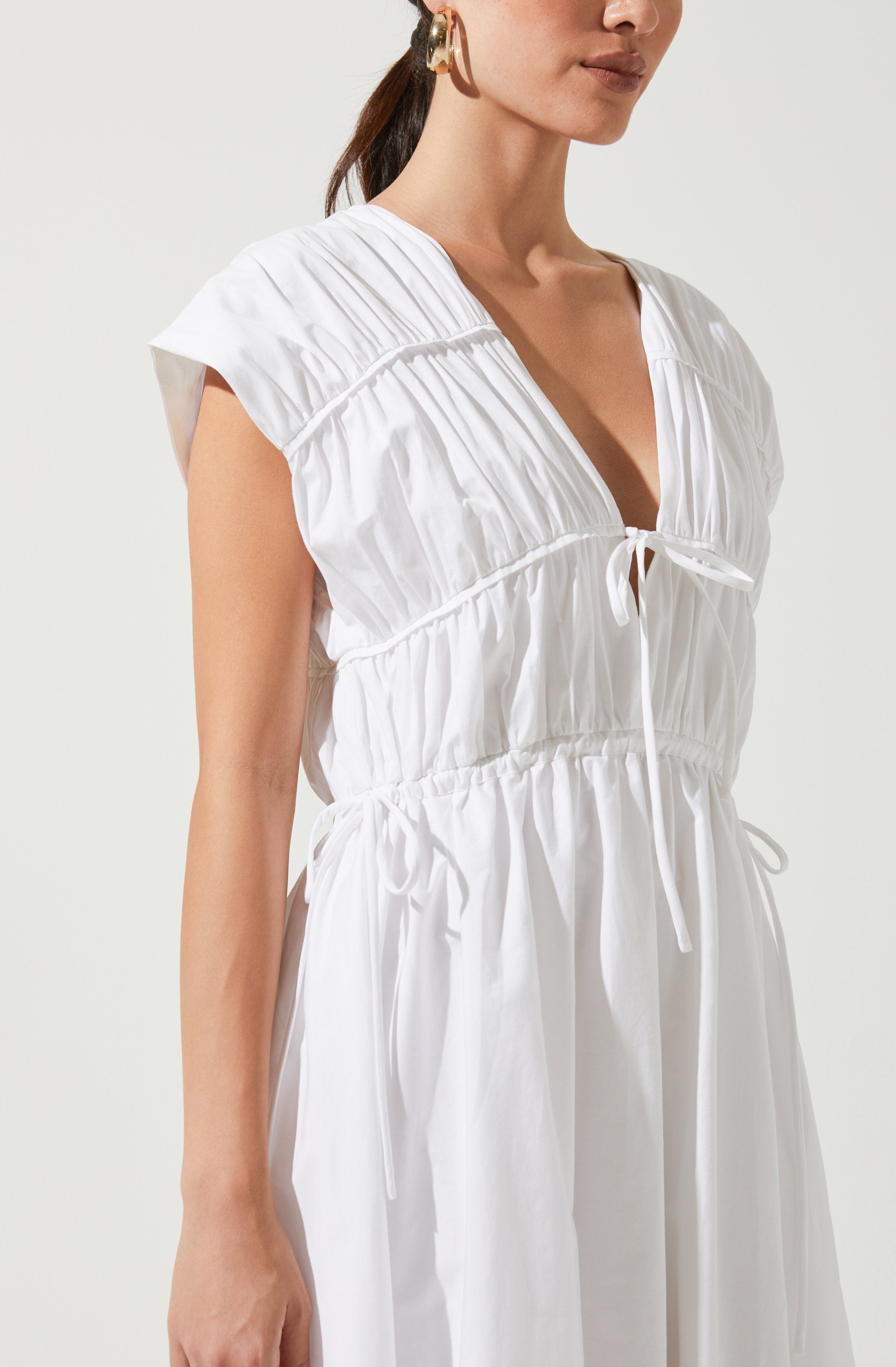 White Solid Dress - This dress is a cool option to pull off your holiday look. It lays emphasis on a stylish V-neck.