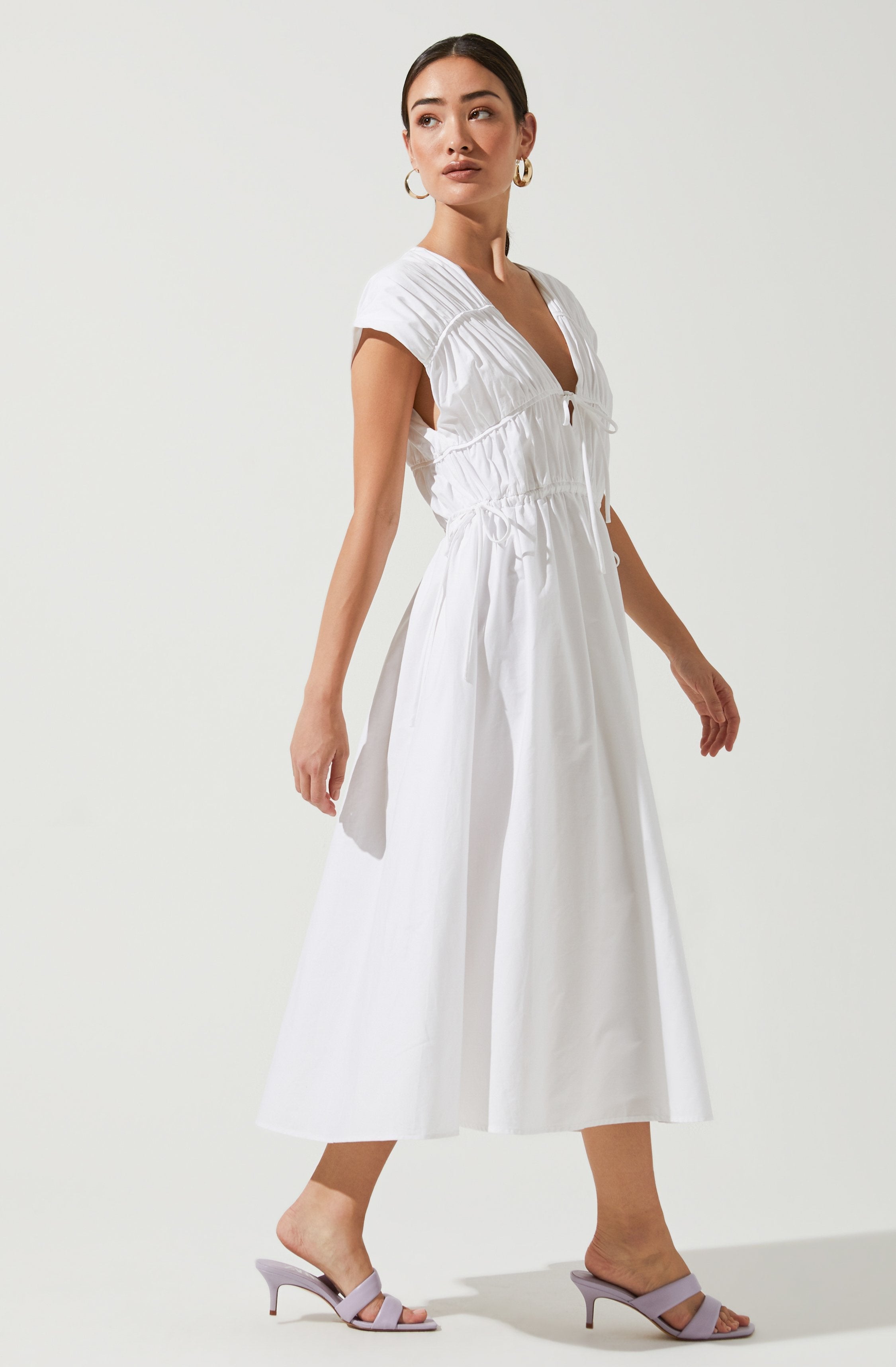 White Solid Dress - This dress is a cool option to pull off your holiday look. It lays emphasis on a stylish V-neck.