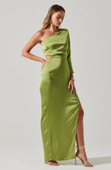 A woman is wearing a floor-length, bright green satin gown with a unique asymmetrical design. The dress features a one-shoulder neckline with a long sleeve on one side, while the other shoulder is bare. There is a cutout on the side of the waist, revealing a hint of skin. The gown has a thigh-high slit on one side, exposing her leg. She is accessorized with large hoop earrings, bracelets, and strappy high-heeled sandals.