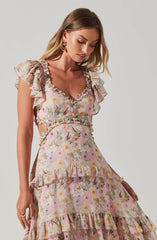 The dress features a floral pattern with soft pastel colors, predominantly pink, yellow, and lavender. It has ruffled details on the sleeves, neckline, and tiered skirt. The fabric appears lightweight and flowy, giving the dress a delicate and feminine appearance.