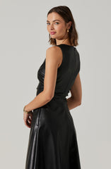 A woman is wearing a sleeveless, fitted black leather dress that extends down to her ankles.