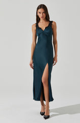 A woman is wearing a long, teal satin evening gown with black lace shoulder straps. The dress features a sweetheart neckline, a high slit on the front left side revealing her leg, and a fitted silhouette that reaches the floor. She is also wearing black high heels with embellishments and pearl earrings.