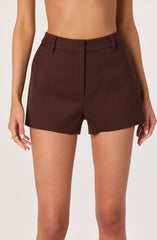 A person is wearing high-waisted dark brown shorts with a tailored design, featuring belt loops and a front zipper closure. The shorts have a smooth, structured appearance and are worn without a top.