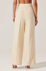 A person is wearing high-waisted, wide-leg pants in a light beige or cream color made from a textured, lightweight fabric. The pants have a clean, tailored appearance with vertical seams running down the legs, and a wide waistband that sits above the hips.