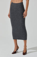 A woman is wearing a high-waisted, ribbed, dark gray knit skirt that extends to mid-calf length. She is also wearing dark-colored high heels.