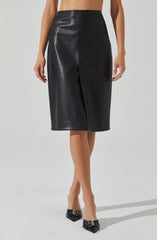 A woman is wearing a high-waisted, knee-length black leather skirt with a front slit. She is also wearing black pointed-toe heels with decorative buckle details.