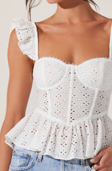A white eyelet sleeveless top with ruffled shoulder straps, a fitted bodice with embroidered floral patterns, a scalloped neckline, and a peplum hem with gathered fabric featuring similar eyelet detailing.