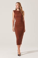 A woman is wearing a sleeveless, form-fitting, ribbed, rusty brown midi dress with slightly padded shoulders. She pairs it with black open-toe heels.