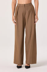 A person is wearing high-waisted, wide-leg brown dress pants with a subtle vertical pinstripe pattern. The pants feature a front zipper closure and belt loops, with pleats at the waist. The overall style is tailored and professional.