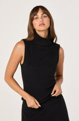 A woman is wearing a sleeveless black turtleneck sweater with a ribbed collar.